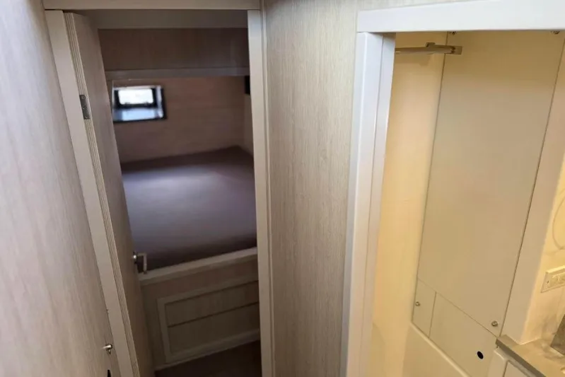 Sweet 2 Bad Yacht Photos Pics Interior view of a 2016 Leopard 404, featuring a compact hallway and bedroom.