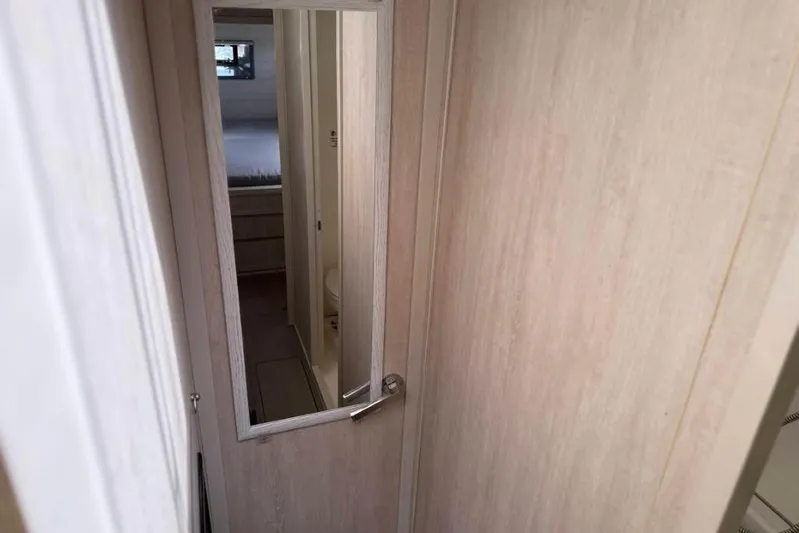 Sweet 2 Bad Yacht Photos Pics Interior view of a 2016 Leopard 404 yacht, featuring a narrow hallway and mirror.