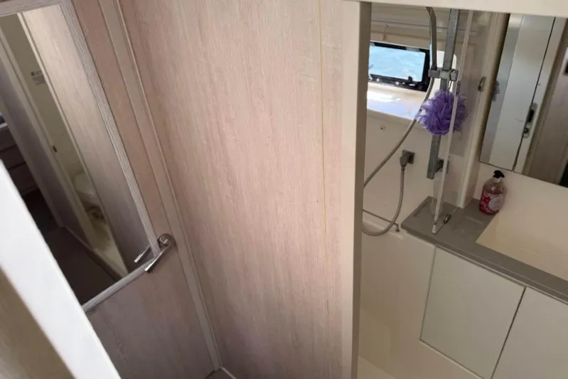 Sweet 2 Bad Yacht Photos Pics Compact bathroom in a 2016 Leopard 404, featuring a shower and sink area.