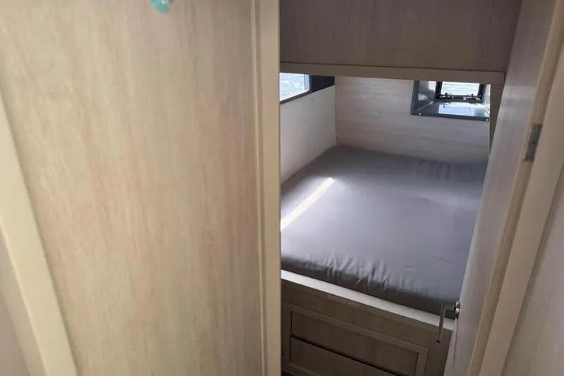 Sweet 2 Bad Yacht Photos Pics Compact cabin interior with bed and window in 2016 Leopard 404 model.