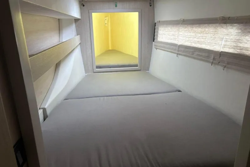 Sweet 2 Bad Yacht Photos Pics Interior of a 2016 Leopard 404 yacht cabin with bed and window blinds.