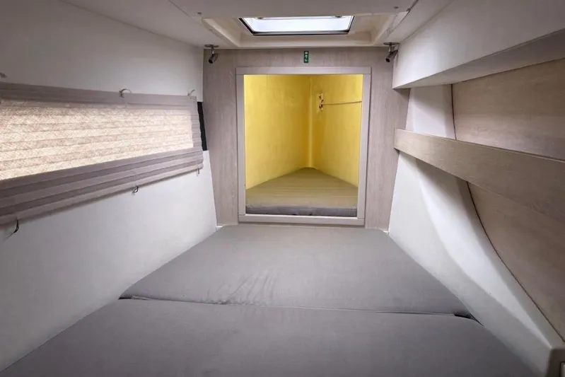 Sweet 2 Bad Yacht Photos Pics Compact cabin interior of 2016 Leopard 404, featuring a skylight and minimalist design.