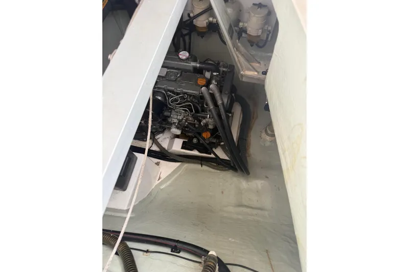 Sweet 2 Bad Yacht Photos Pics Engine compartment of a 2016 Leopard 404 boat, showcasing mechanical components and hoses.