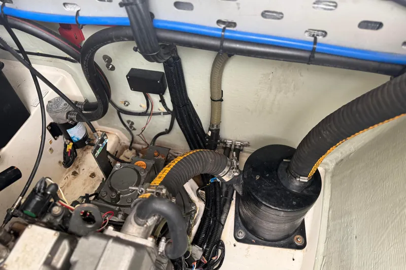 Sweet 2 Bad Yacht Photos Pics Engine compartment of a 2016 Leopard 404 with visible hoses and wiring.