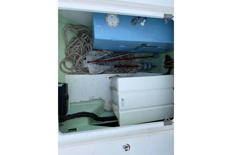 Sweet 2 Bad Yacht Photos Pics Storage compartment in a 2016 Leopard 404 boat with ropes and equipment.
