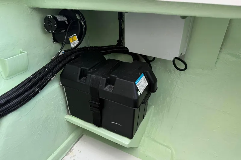 Sweet 2 Bad Yacht Photos Pics Electrical compartment in a 2016 Leopard 404 boat, featuring a battery and wiring.
