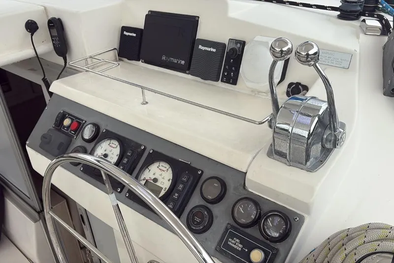 Sweet 2 Bad Yacht Photos Pics Control panel of a 2016 Leopard 404 yacht with steering wheel and navigation instruments.