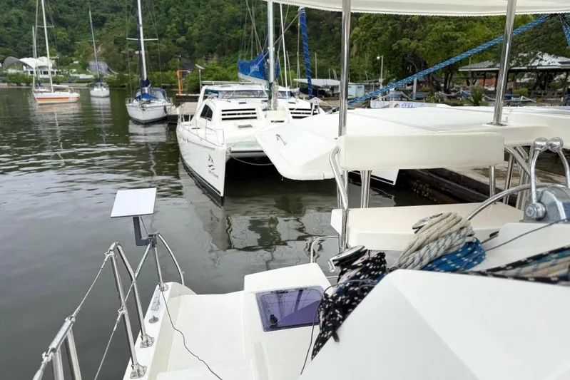 Sweet 2 Bad Yacht Photos Pics Catamaran docked at marina, Leopard 404 model, 2016, surrounded by lush greenery.