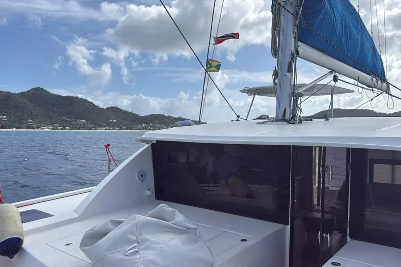Sweet 2 Bad Yacht Photos Pics Sailing on a 2016 Leopard 404 catamaran with scenic coastal views and clear skies.