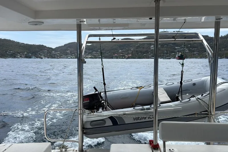 Sweet 2 Bad Yacht Photos Pics Leopard 404 catamaran with inflatable boat on davits, sailing in scenic waters, 2016 model.