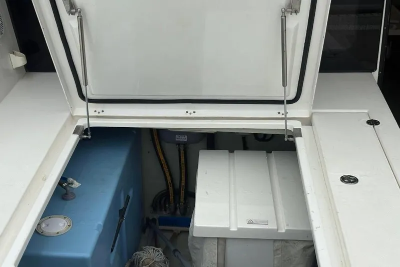 Sweet 2 Bad Yacht Photos Pics Open storage compartment on a 2016 Leopard 404 boat, showing interior components.