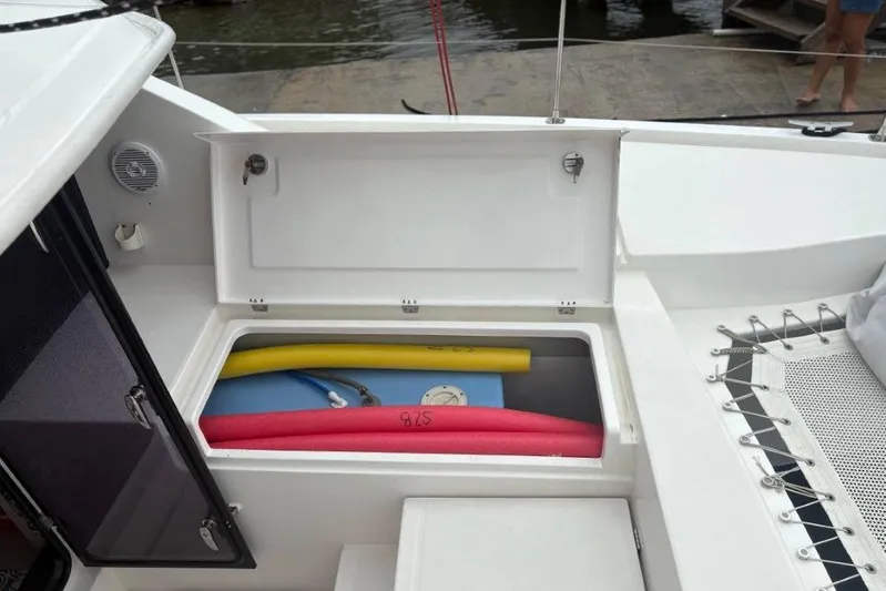 Sweet 2 Bad Yacht Photos Pics Open storage compartment on 2016 Leopard 404 boat with pool noodles and a life jacket.
