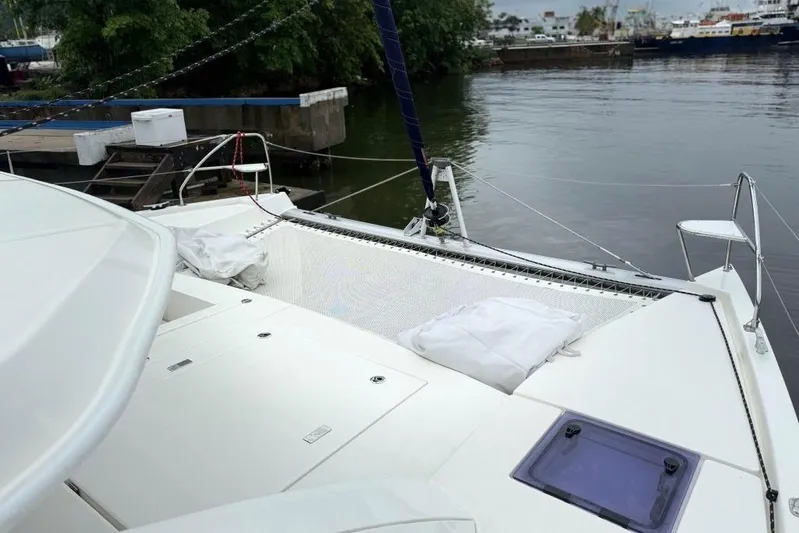 Sweet 2 Bad Yacht Photos Pics 2016 Leopard 404 catamaran docked by a calm waterfront.