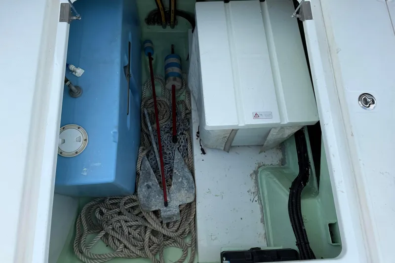 Sweet 2 Bad Yacht Photos Pics Storage compartment of a 2016 Leopard 404 boat with ropes and anchor.