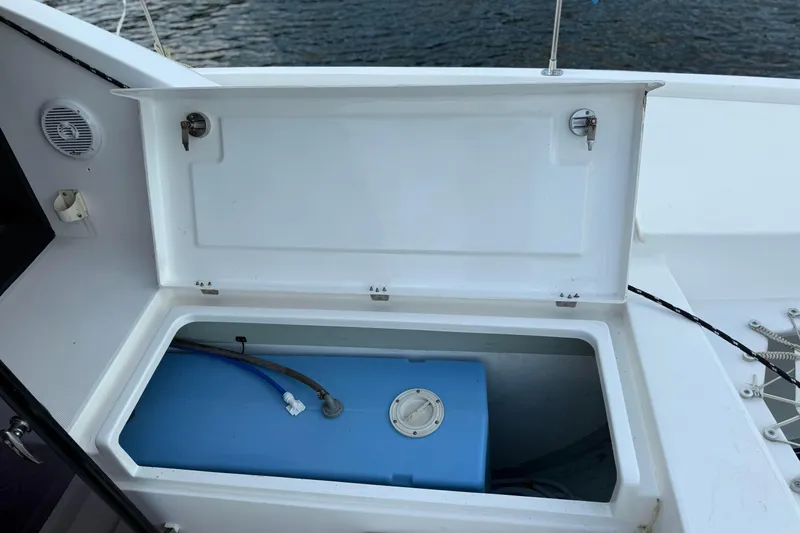 Sweet 2 Bad Yacht Photos Pics Open storage compartment on Leopard 404 boat, featuring a blue water tank, 2016 model.