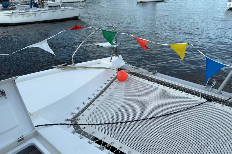 Sweet 2 Bad Yacht Photos Pics Leopard 404 catamaran deck with colorful flags and netting, 2016 model.