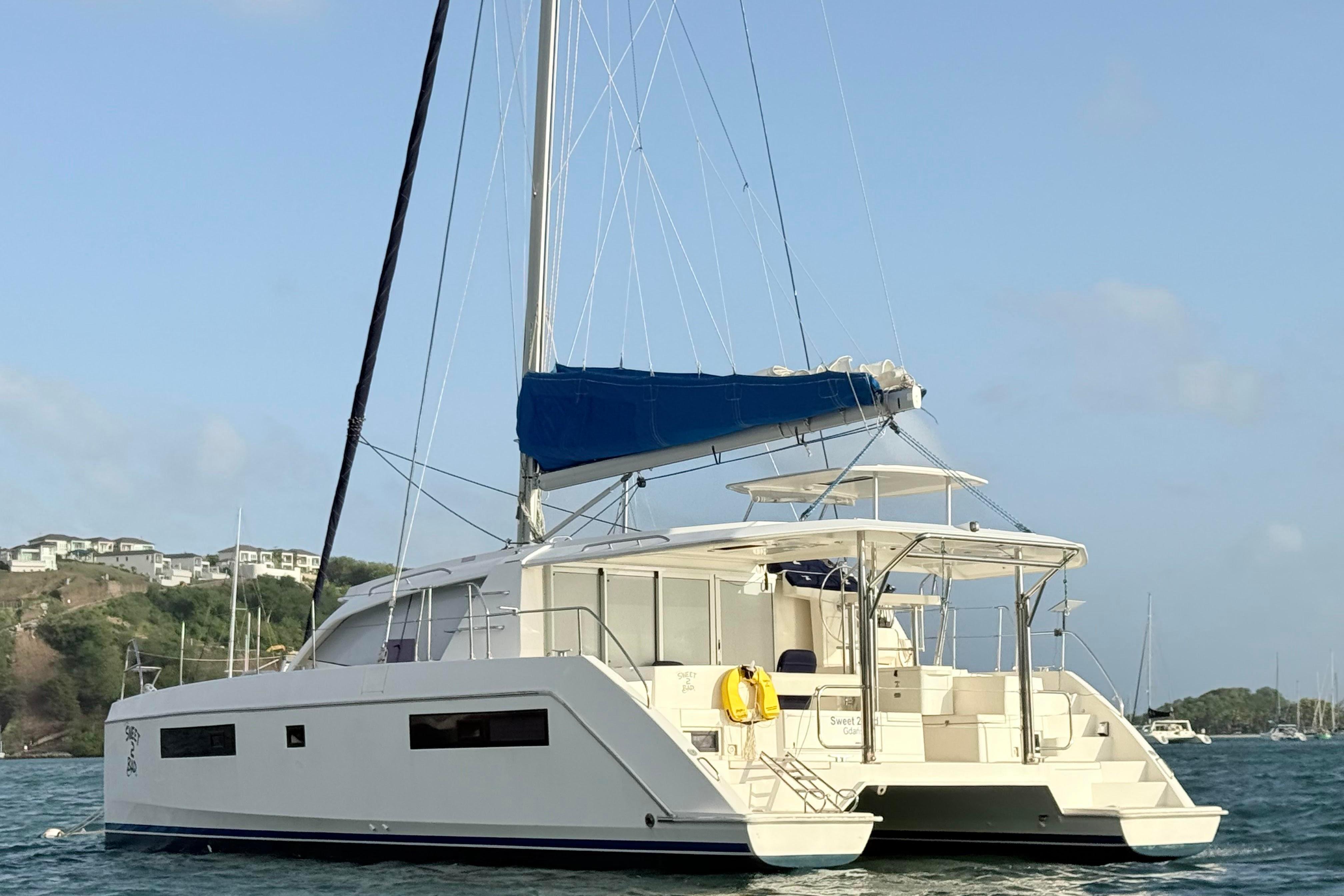 2017 Leopard 40 catamaran sailing in a scenic coastal area.