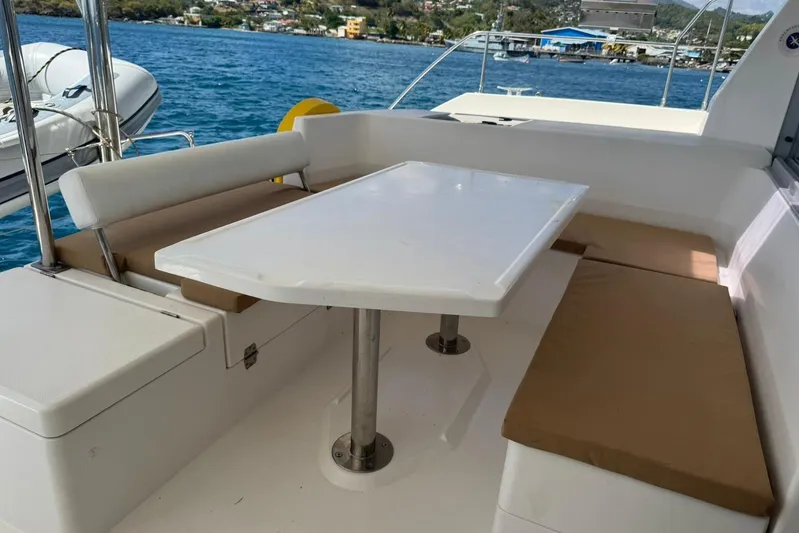 Sweet 2 Bad Yacht Photos Pics Outdoor seating area on a 2017 Leopard 40 catamaran with ocean view.