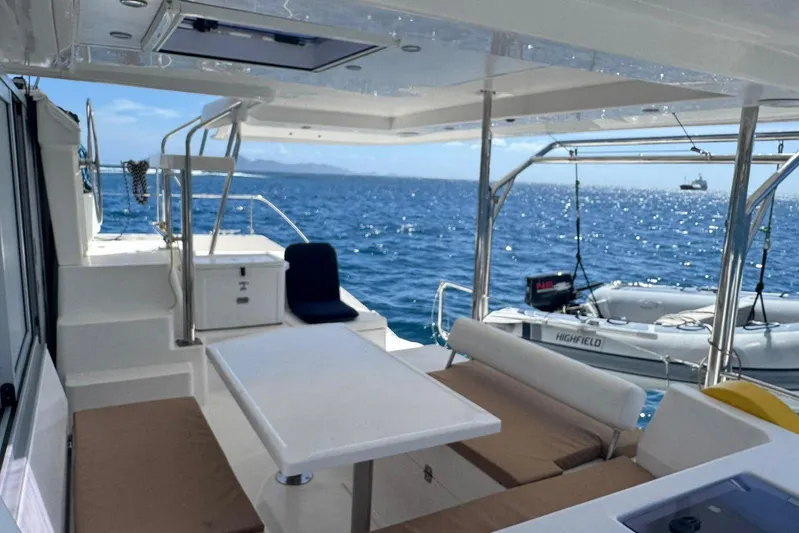 Sweet 2 Bad Yacht Photos Pics 2017 Leopard 40 catamaran deck with seating, table, and ocean view.