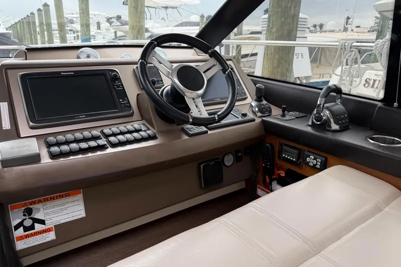Top Nach Yacht Photos Pics Cockpit of 2017 Prestige 500S yacht with steering wheel and navigation controls.