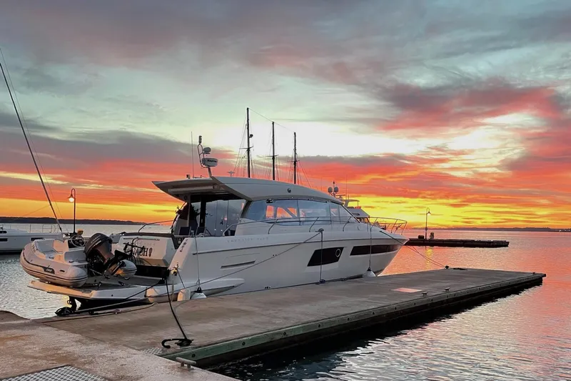 Top Nach Yacht Photos Pics Luxury 2017 Prestige 500S yacht docked at sunset, vibrant sky reflecting on water.