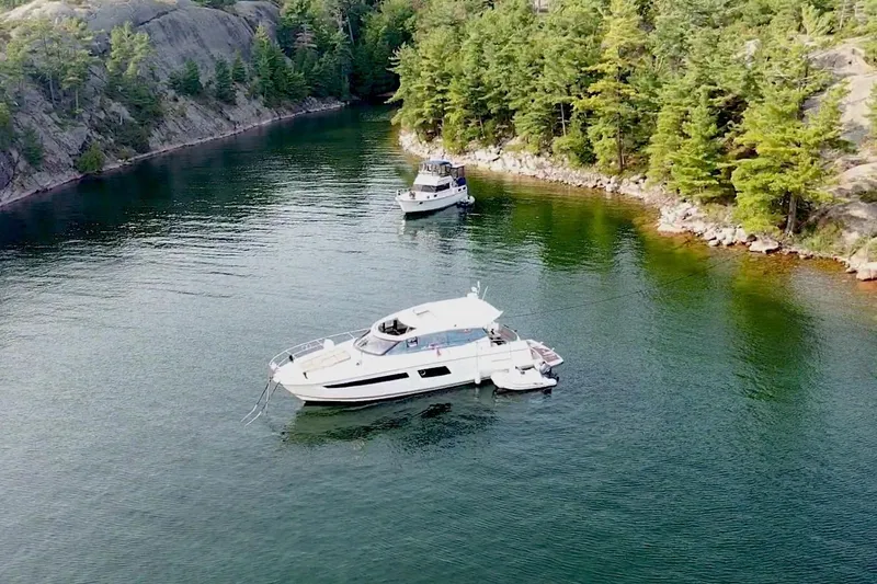 Top Nach Yacht Photos Pics 2017 Prestige 500S yacht anchored in a scenic, forested cove.