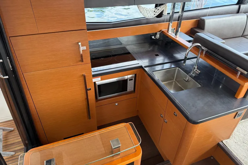 Top Nach Yacht Photos Pics Modern kitchen interior of 2017 Prestige 500S yacht with wood cabinetry and stainless steel sink.