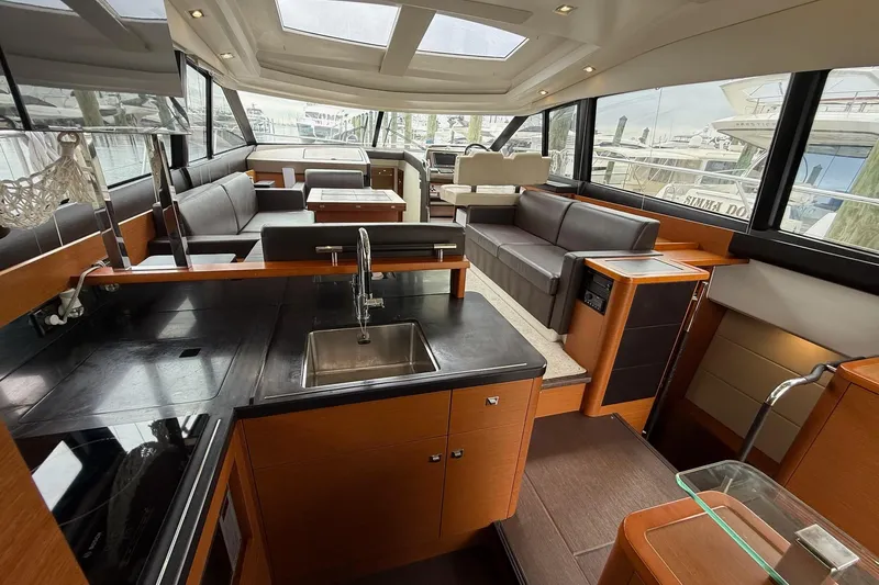 Top Nach Yacht Photos Pics Luxurious interior of a 2017 Prestige 500S yacht with modern kitchen and seating area.