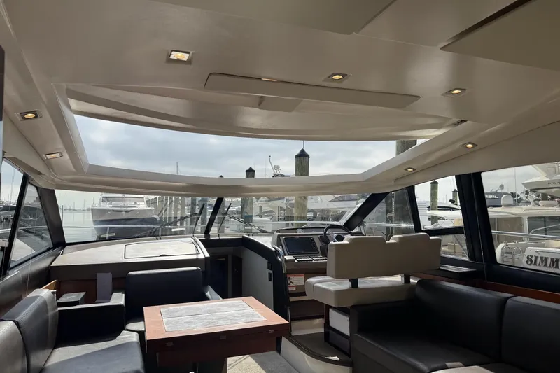 Top Nach Yacht Photos Pics Luxurious interior of a 2017 Prestige 500S yacht with modern seating and navigation area.