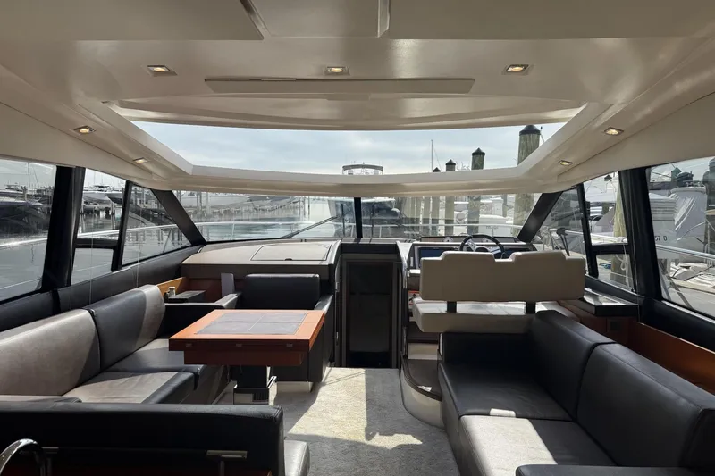 Top Nach Yacht Photos Pics Luxurious interior of a 2017 Prestige 500S yacht with panoramic windows and elegant seating.
