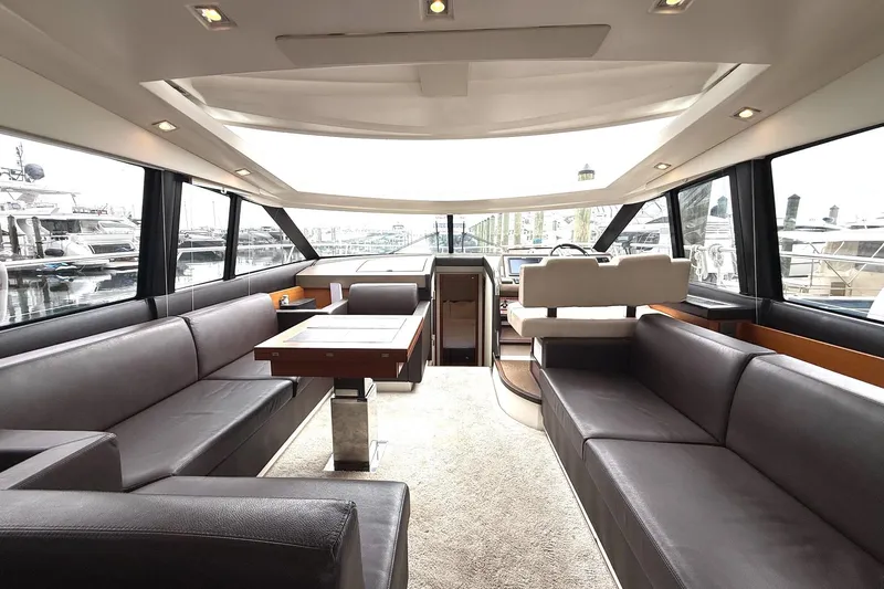 Top Nach Yacht Photos Pics Luxurious interior of a 2017 Prestige 500S yacht with elegant seating and panoramic windows.