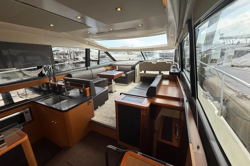 Top Nach Yacht Photos Pics Luxurious interior of a 2017 Prestige 500S yacht with modern furnishings and marina view.