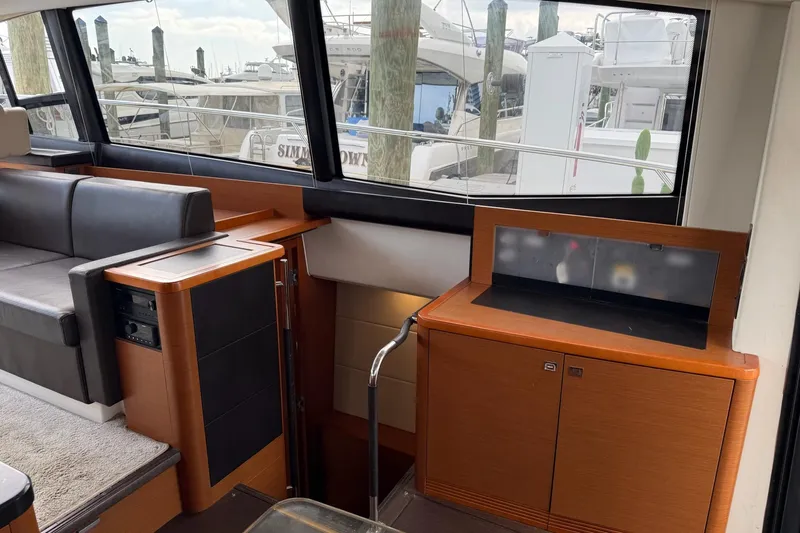 Top Nach Yacht Photos Pics Interior of 2017 Prestige 500S yacht with modern wood cabinetry and large windows.
