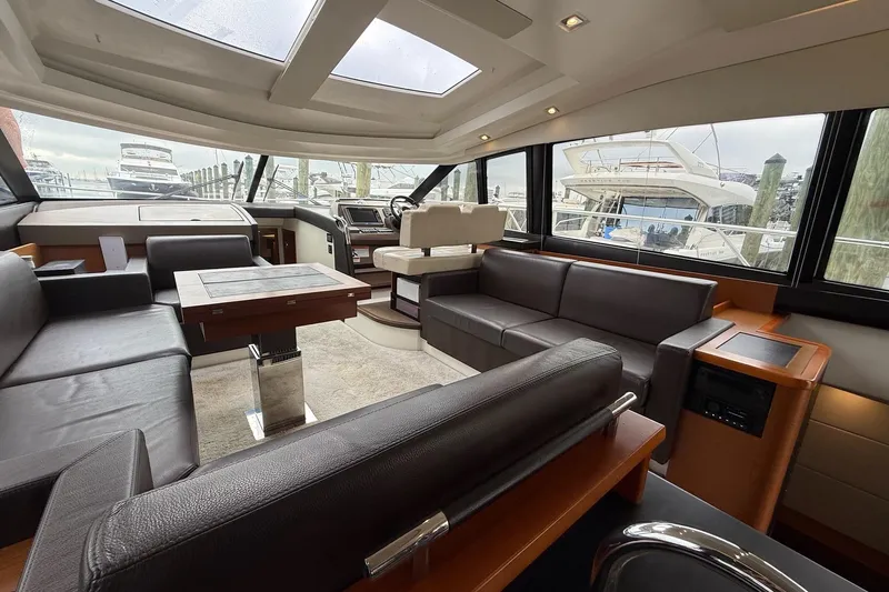 Top Nach Yacht Photos Pics Luxurious interior of a 2017 Prestige 500S yacht with leather seating and panoramic windows.