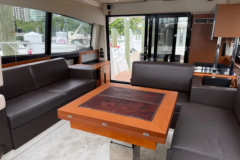 Top Nach Yacht Photos Pics Interior of 2017 Prestige 500S yacht with luxurious seating and elegant table design.