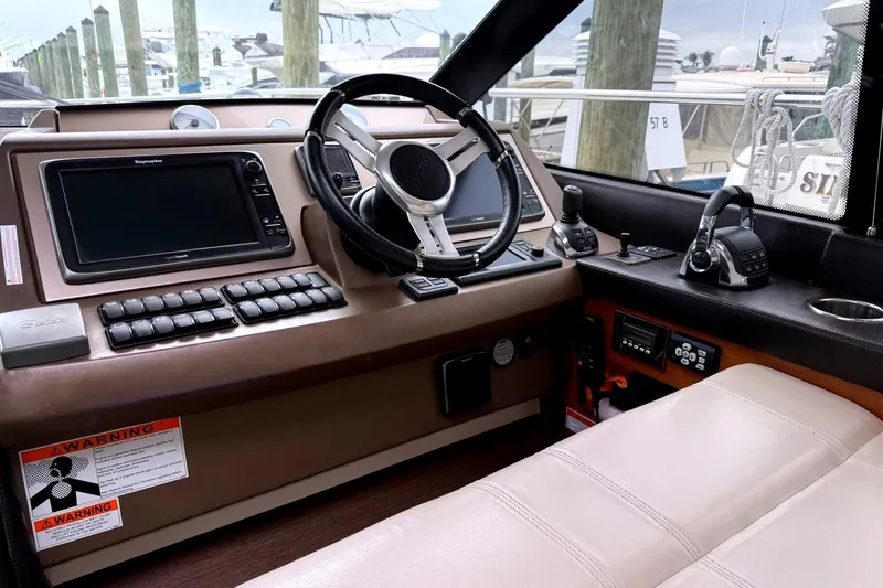 Top Nach Yacht Photos Pics Cockpit of 2017 Prestige 500S yacht with steering wheel and navigation controls.