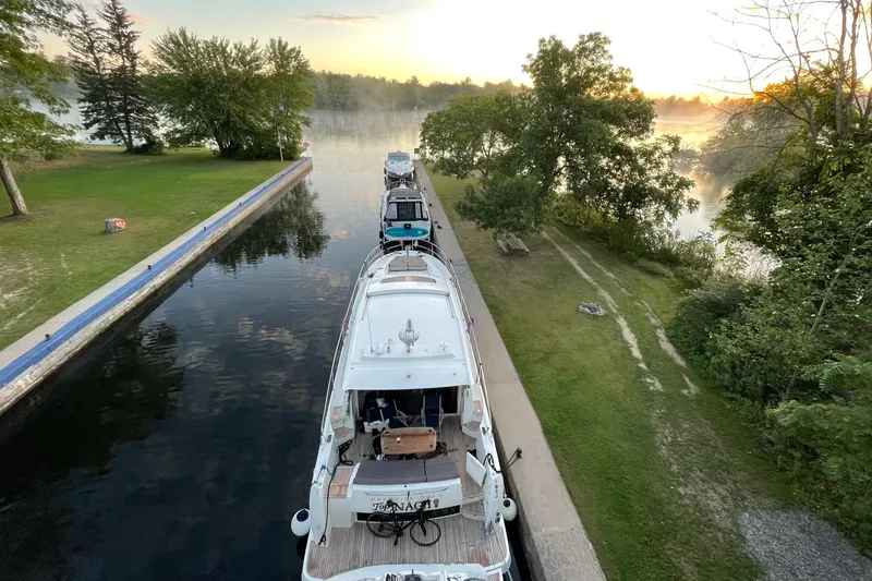 Top Nach Yacht Photos Pics 2017 Prestige 500S yacht docked on a serene river at sunrise.