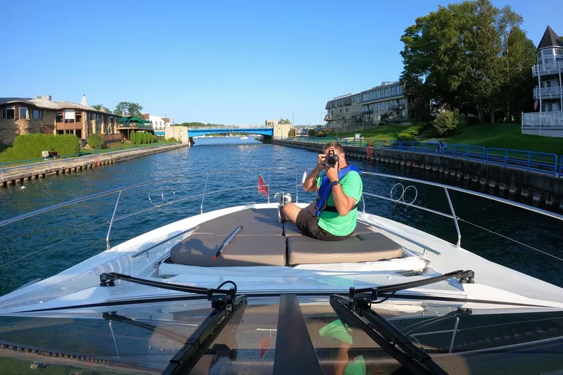 Top Nach Yacht Photos Pics Man photographing from 2017 Prestige 500S yacht on a scenic canal.