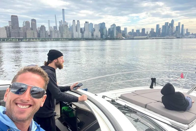 Top Nach Yacht Photos Pics People enjoying a boat ride on a 2017 Prestige 500S with city skyline backdrop.