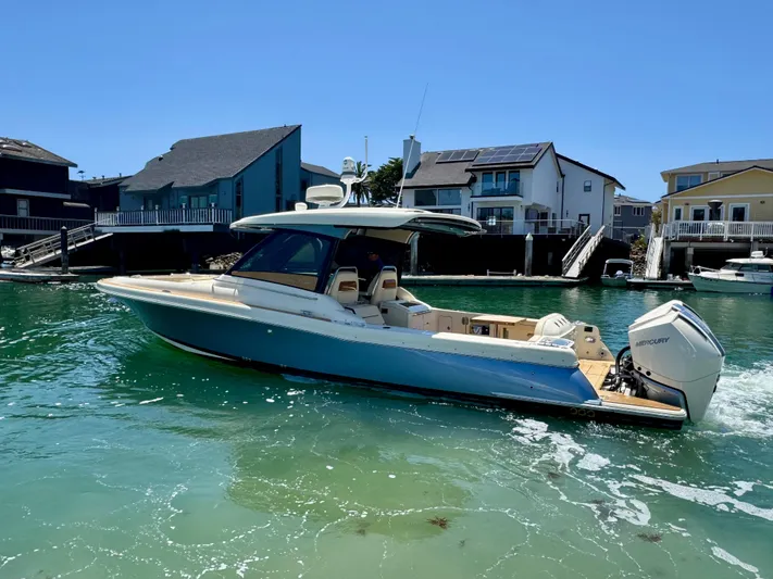 Sea Dragon Yacht Photos Pics 2023 Chris-Craft Calypso 35 boat cruising in a sunny waterfront setting.