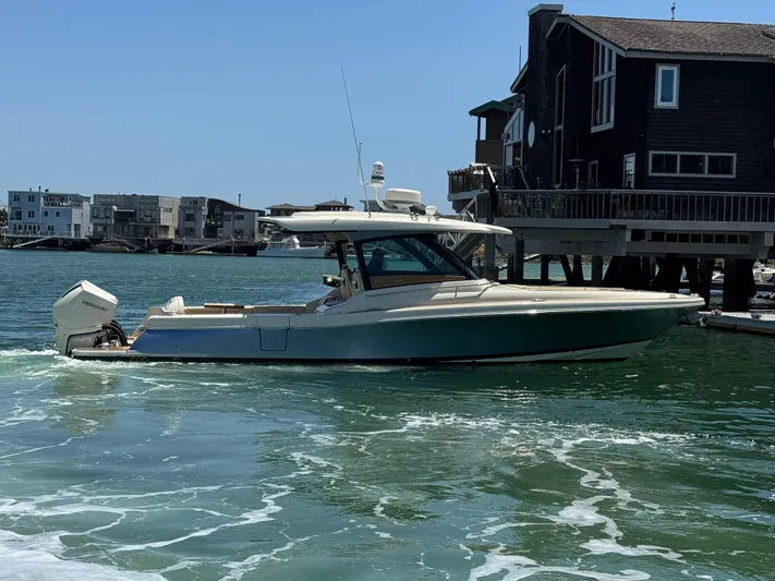 Sea Dragon Yacht Photos Pics 2023 Chris-Craft Calypso 35 boat cruising near waterfront homes.