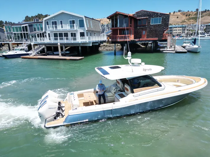 Sea Dragon Yacht Photos Pics 2023 Chris-Craft Calypso 35 boat cruising near waterfront homes.