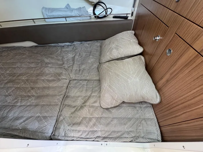Sea Dragon Yacht Photos Pics 2023 Chris-Craft Calypso 35 cabin interior with bed and wooden cabinetry.