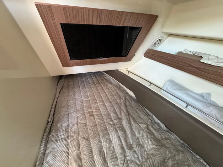 Sea Dragon Yacht Photos Pics 2023 Chris-Craft Calypso 35 cabin interior with bed and wall-mounted TV.