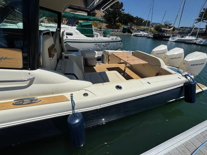 Sea Dragon Yacht Photos Pics 2023 Chris-Craft Calypso 35 boat docked, featuring luxurious seating and powerful Mercury engines.