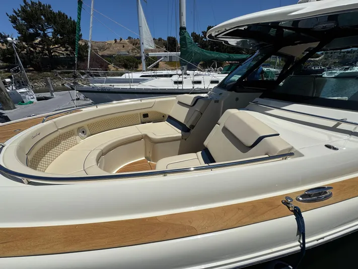 Sea Dragon Yacht Photos Pics 2023 Chris-Craft Calypso 35 boat with luxurious seating and elegant design at a marina.