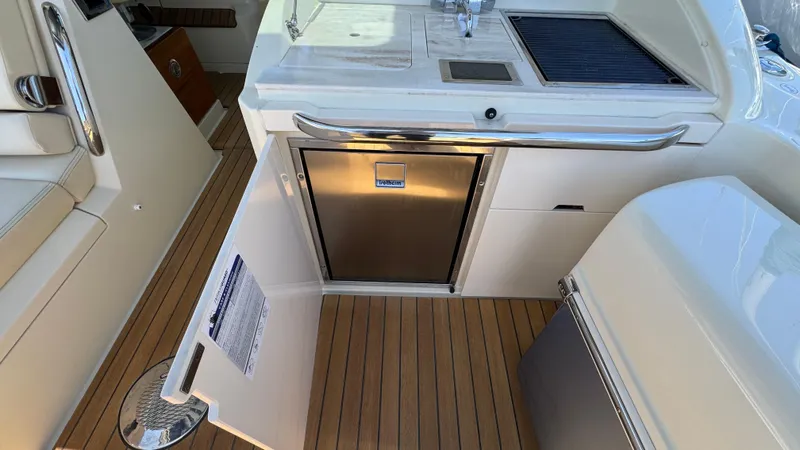 Sea Dragon Yacht Photos Pics 2023 Chris-Craft Calypso 35 boat interior with kitchenette and stainless steel appliances.