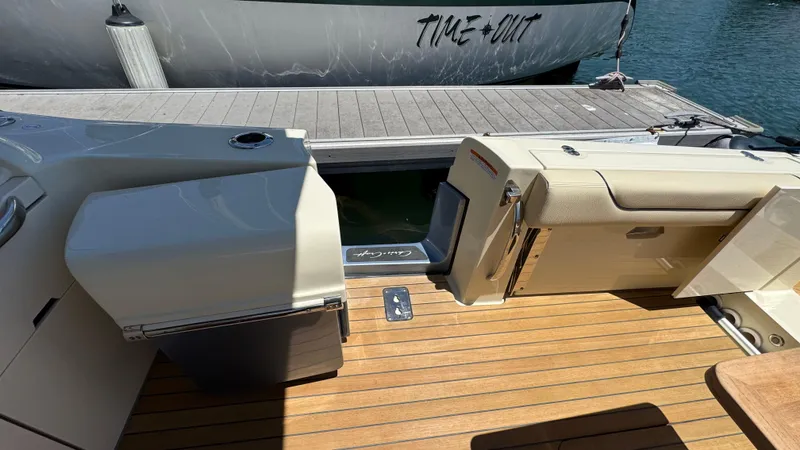 Sea Dragon Yacht Photos Pics 2023 Chris-Craft Calypso 35 boat interior with teak flooring and dock view.