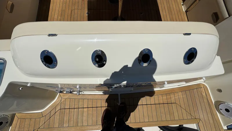 Sea Dragon Yacht Photos Pics 2023 Chris-Craft Calypso 35 boat deck with rod holders and teak flooring.