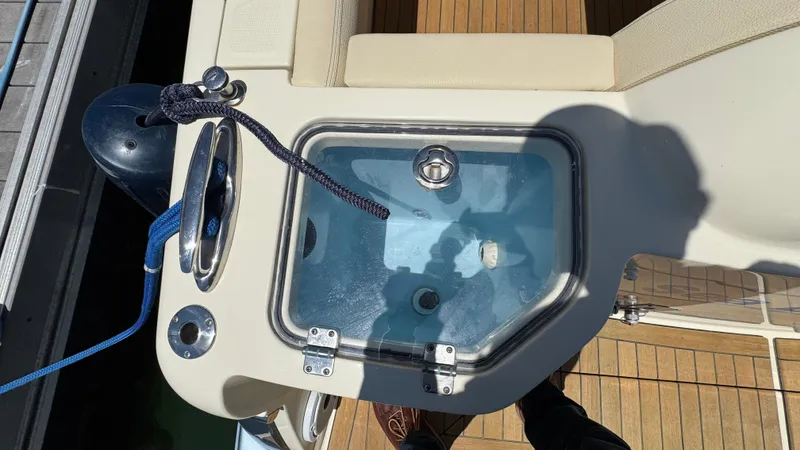 Sea Dragon Yacht Photos Pics 2023 Chris-Craft Calypso 35 boat deck with livewell and seating area.